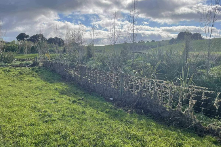 Before . . . A fence featuring flood debris on a farm in South Otago.